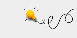 Brainstorming,Concept,With,A,Yellow,Light,Bulb,-,Flat,Lay